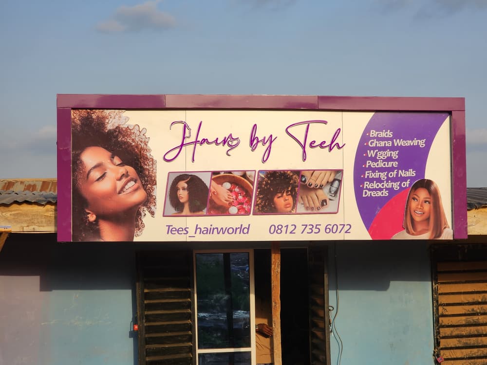 Illuminated Hair by Teeh salon signboard featuring services list and portrait imagery