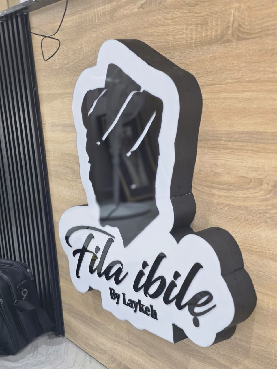 Sculpted 3D Fila Ibile by Laykeh signage with mirrored cap silhouette