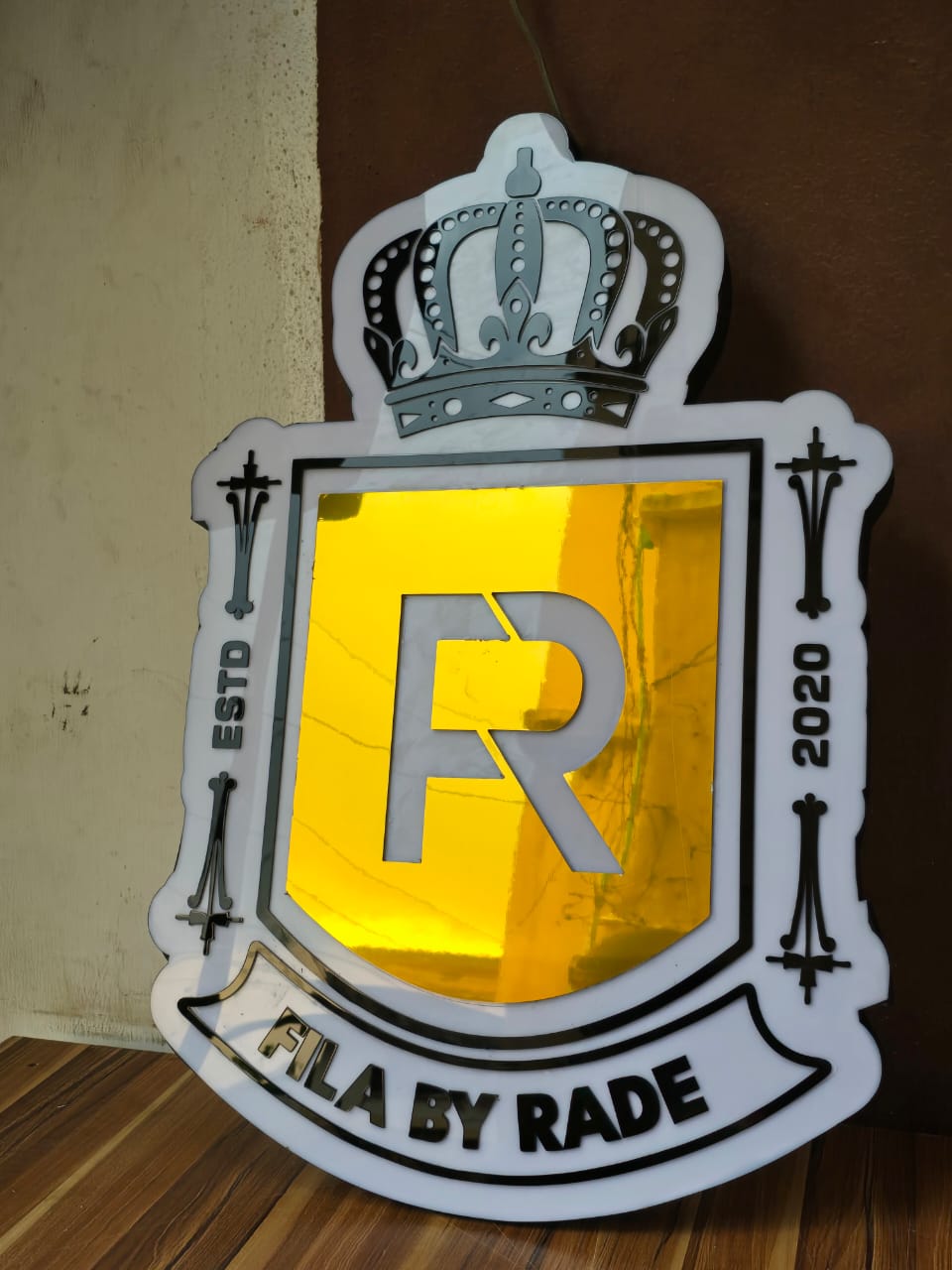 Mirror-gold Fila by Rade royal crest signage with crown and ESTD 2020 mark