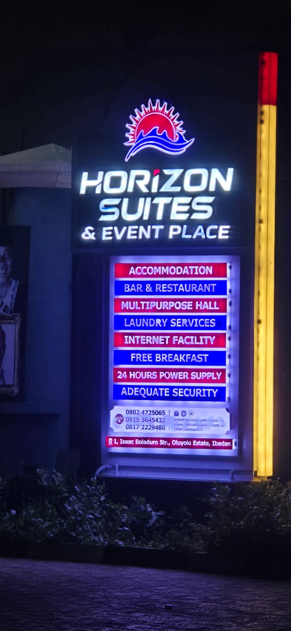 Illuminated multi-panel signage for Horizon Suites & Event Place at night
