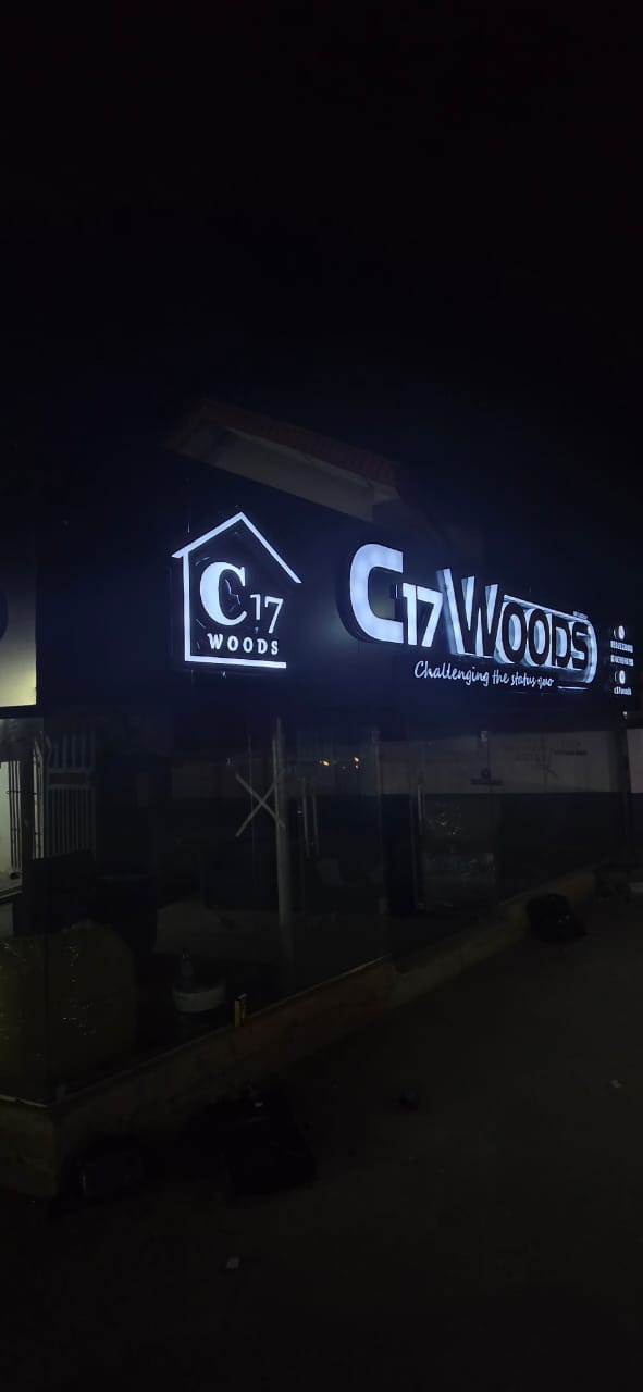 Bright gold neon sign glowing with Ajise bi Oyo laari text