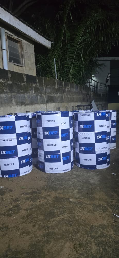 Bulk production of 1xBet branded checkered photo booth barrel wraps ready for deployment