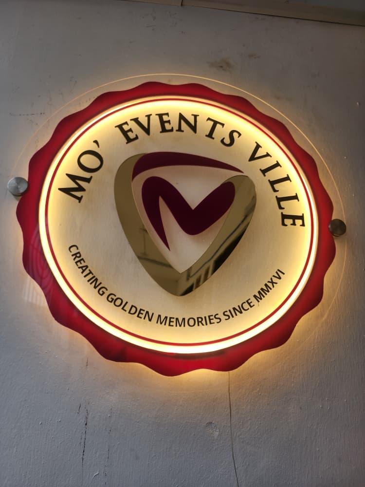 Backlit Mo' Events Ville circular badge sign — Creating Golden Memories Since MMXVI