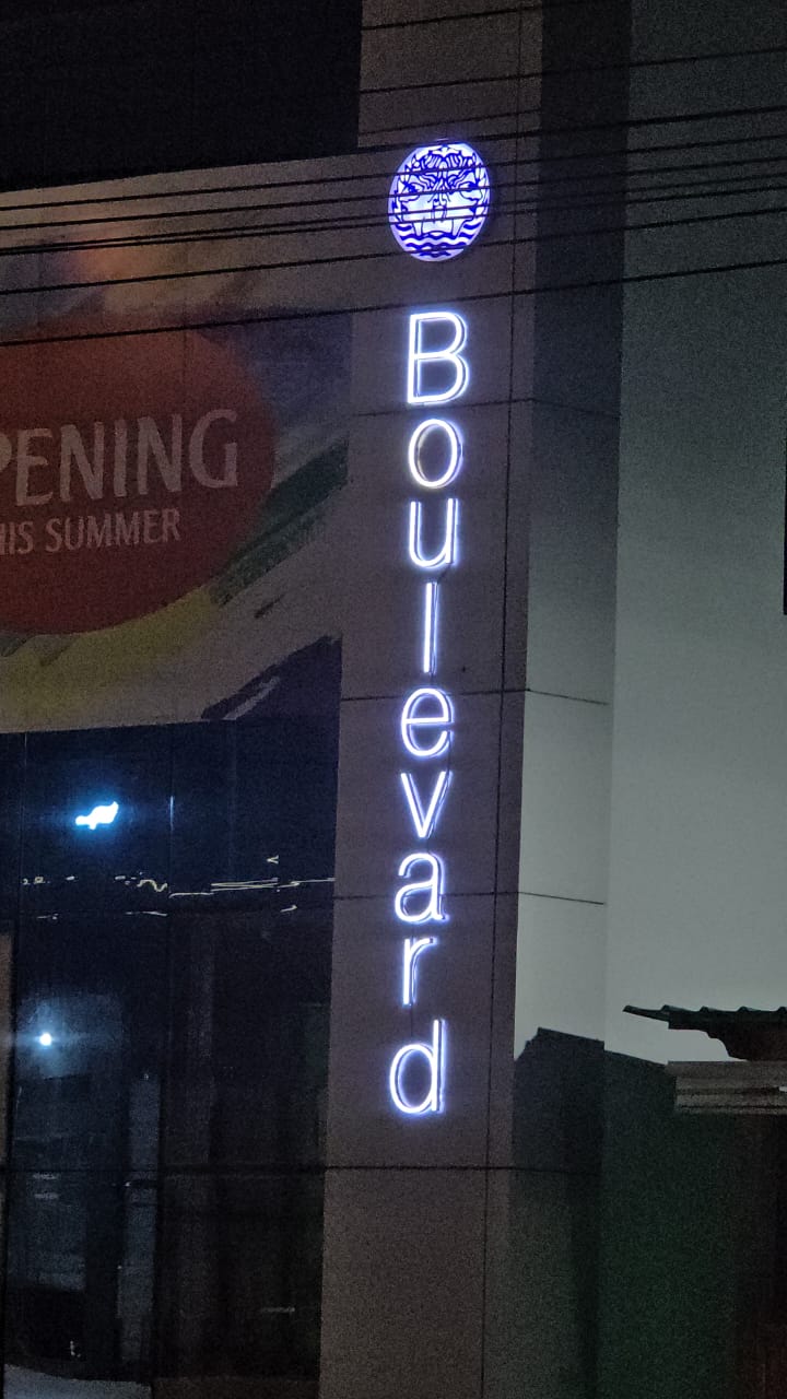 Vertical illuminated Boulevard channel-letter signage on building facade