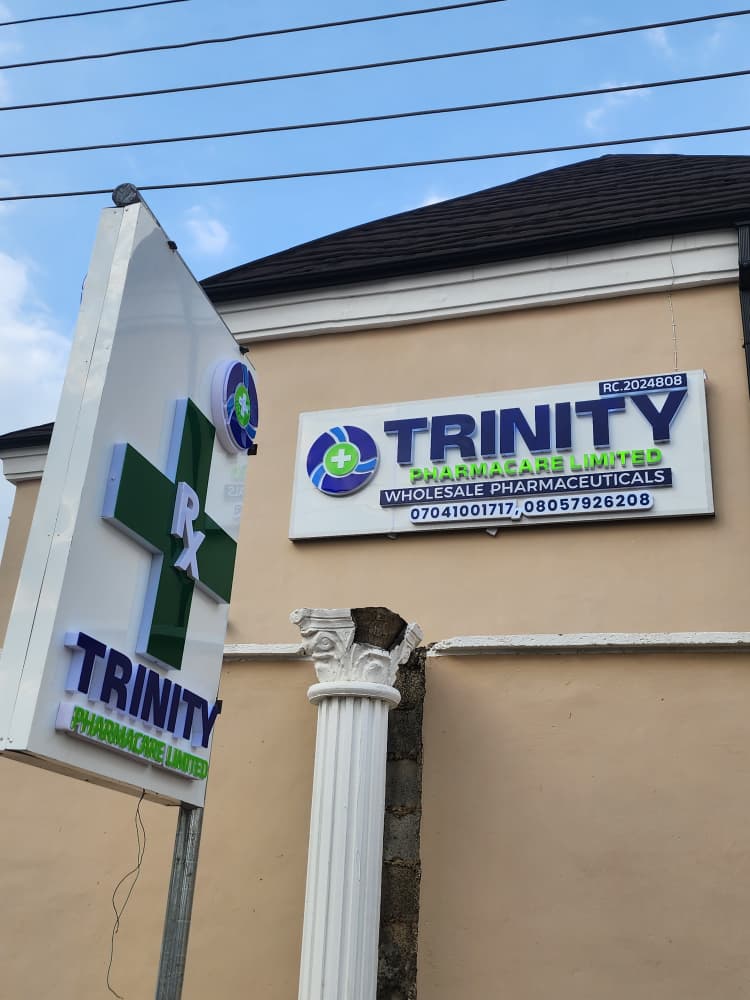 Trinity Pharmacare Limited illuminated facade signboard and Rx pharmacy pylon at building entrance